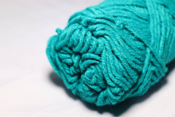cyan colored yarn closeup on white background - Photo, image