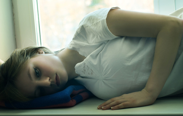 Beautiful girl lying and longs - Foto, imagen
