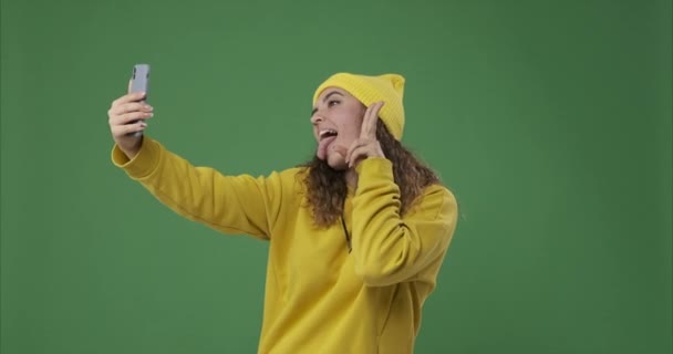 Woman taking selfie and photo messaging using mobile phone - Video, Çekim