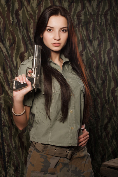 Girl uniform with a gun. Camouflage. - Foto, afbeelding