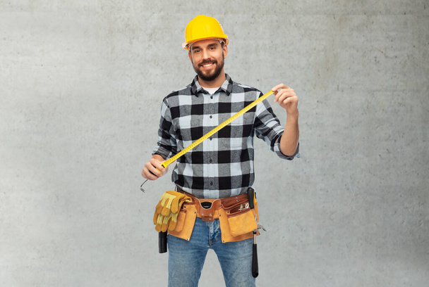 happy male worker or builder in helmet with ruler - Φωτογραφία, εικόνα