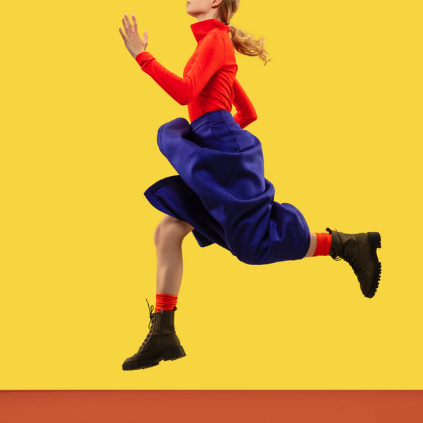 Молода жіноча модель в яскравому повсякденному одязі ізольована на жовтому студійному фоні
 - Фото, зображення