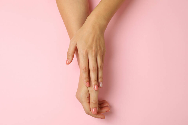 Cute female hands on pink background, top view - Foto, Imagem
