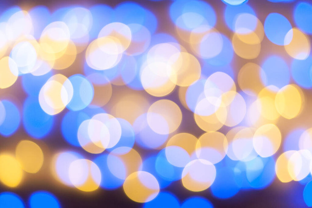 Festive garland bokeh background defocused. Background for greeting cards and postcards. Round bokeh balls. Round bokeh light. - Photo, Image