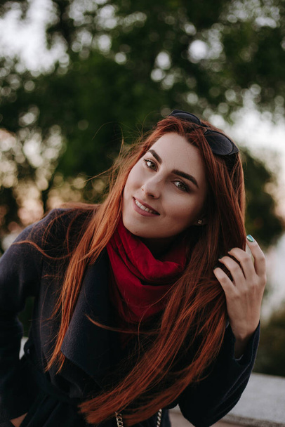 Pretty woman with green eyes and wide eyebrows looking at camera and smiling. Model dressed in warm clothes. - Фото, зображення