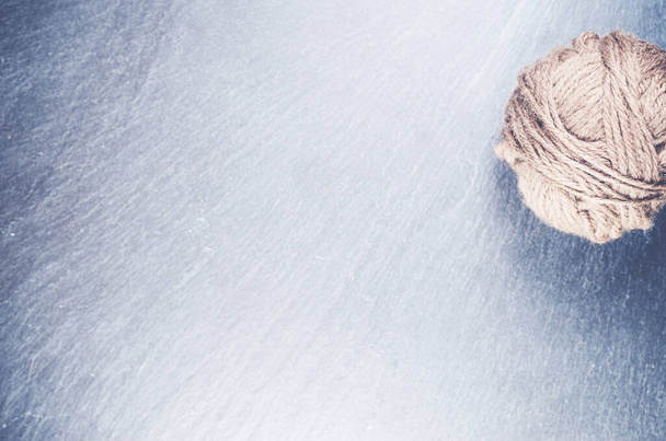 A high angle shot of a ball of yarn on a rough surface - copy space - Fotó, kép