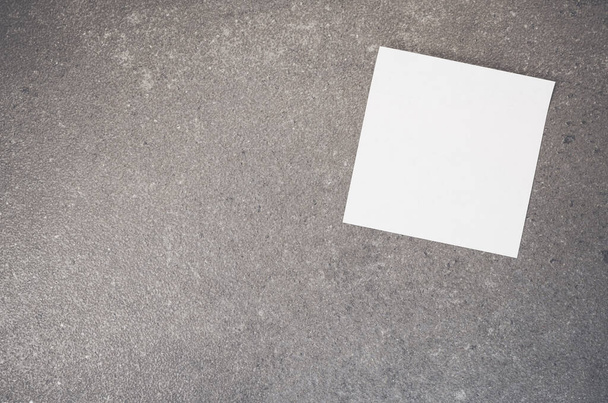A top view of a blank paper memo on a rough-textured surface with copy space - Fotografie, Obrázek
