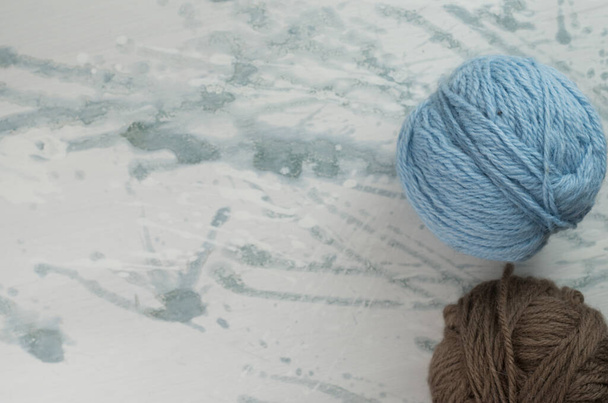 A high angle shot of balls of yarn on a rough surface - Фото, зображення