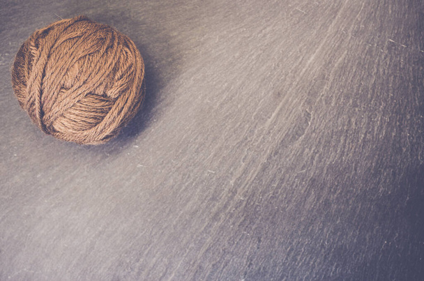 A high angle shot of a ball of yarn on a rough surface - copy space - Fotoğraf, Görsel