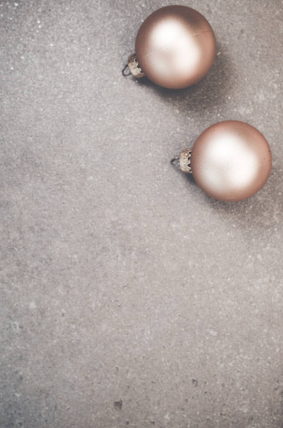 A vertical top view of shiny Christmas ornaments on a smooth surface with copy space - 写真・画像