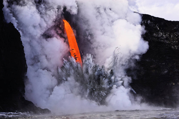 Lava flowing into ocean from the cliff on Big island Hawaii - Photo, Image