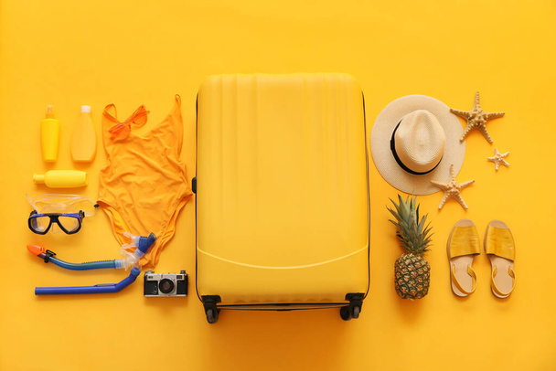 Set of beach accessories with suitcase on color background - Fotoğraf, Görsel