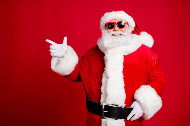 Portrait of his he nice handsome cheerful cheery bearded Santa father showing copy space advice idea like follow subscribe event isolated bright vivid shine vibrant red color background - Fotografie, Obrázek