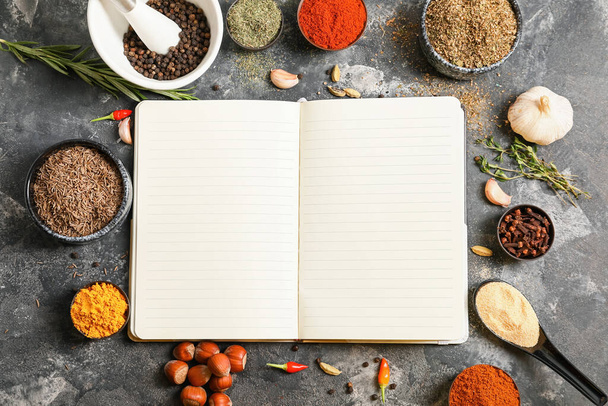 Notebook for recipes and spices on grey table - Фото, зображення