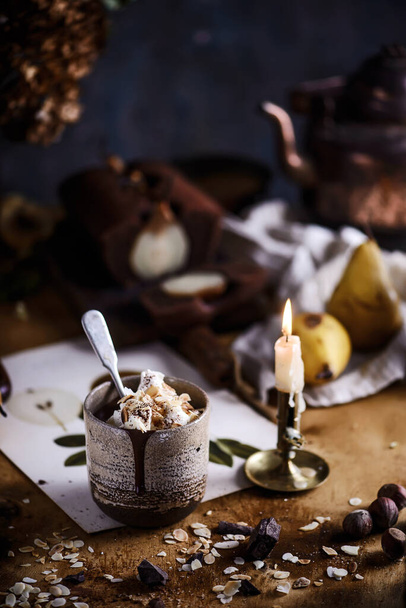 Hot chocolate with whipped cream and toasted almonds in a ceramic glass.selective focus - 写真・画像