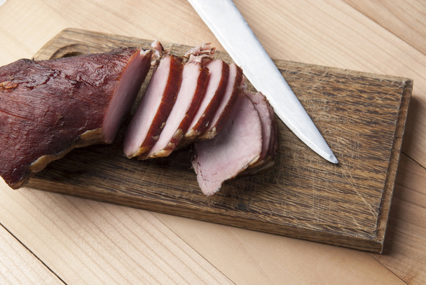 Smoked meat on wooden cutting board - Photo, Image