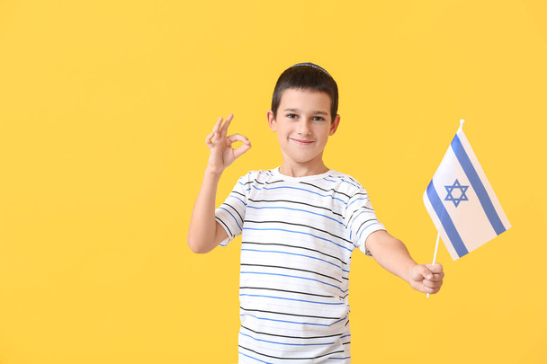 Little boy with the flag of Israel showing OK on color background - Photo, Image