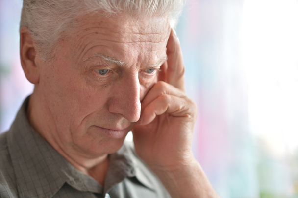 Close-up portrait of a senior man thinking about something - Fotó, kép