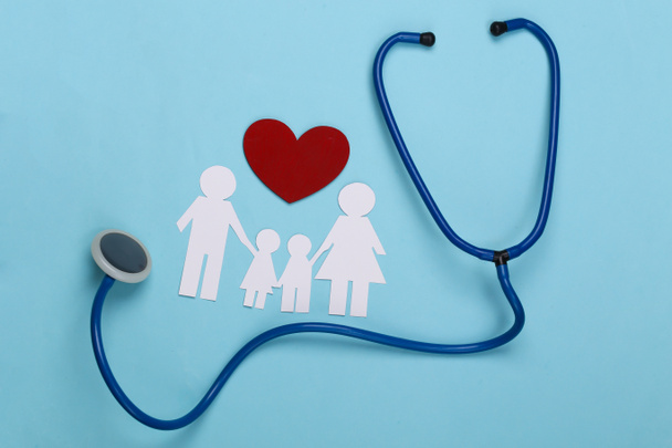 Stethoscoop en papieren ketting familie, rood hart op blauwe achtergrond, ziektekostenverzekering concept - Foto, afbeelding