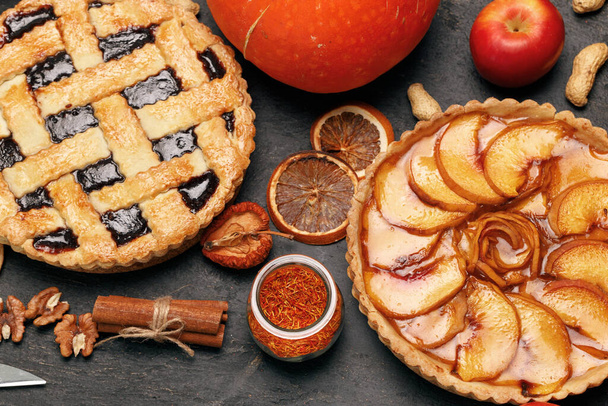 Berry tart pie and apple tart pie on black background - 写真・画像