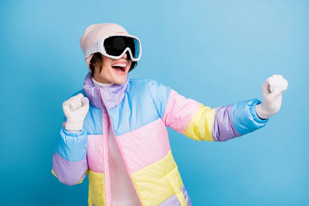 Photo of happy positive young woman wear sport ski clothes cheerful dance winter break isolated on blue color background - Foto, Imagen
