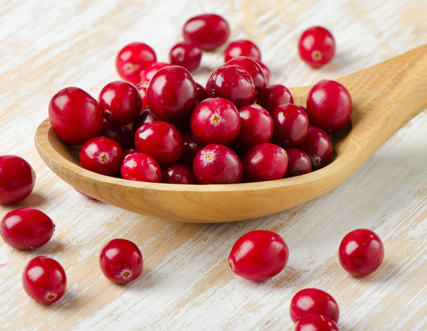 Cranberries in a  wooden spoon - Photo, image