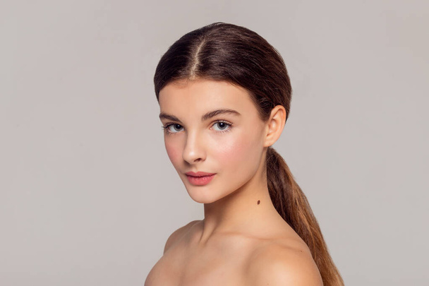 health and beauty concept - Beautiful Young Woman with Clean Fresh Skin touch own face . Facial treatment . Cosmetology , beauty and spa . - Foto, immagini