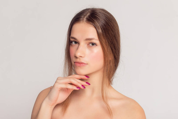 health and beauty concept - Beautiful Young Woman with Clean Fresh Skin touch own face . Facial treatment . Cosmetology , beauty and spa . - Valokuva, kuva