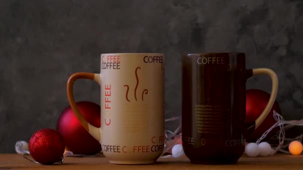 Steaming Christmas coffee cups bokeh lights decoration. Winter holidays music background, cozy home good morning concept, New year festive song. Two mugs with hot tea drink. Love romance couple date. - Footage, Video