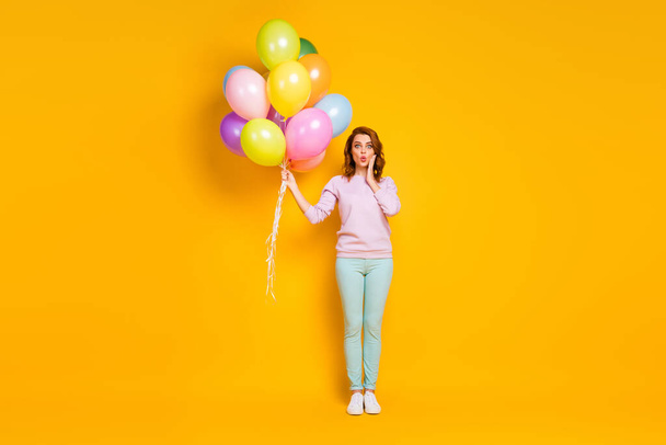 Full length photo of crazy astonished woman get receive gift present air baloons for 8-march she hold impressed touch hands face wear good look clothes isolated over shine color background - Foto, imagen