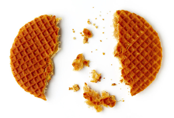 Broken Dutch stroopwafel with caramel and honey isolated on white background, top view - Photo, image