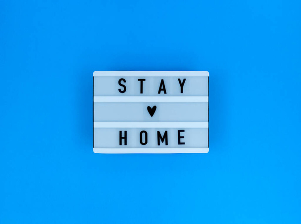 Light box with Stay home quote on blue background. - Valokuva, kuva