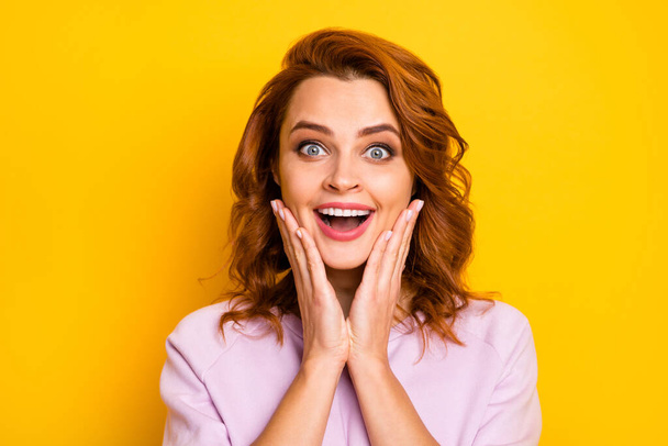 Closeup photo of beautiful ginger lady hands on cheeks open mouth listen cool good news unexpected surprise wear pink pullover isolated yellow color background - Fotoğraf, Görsel