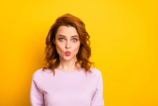 Closeup photo of beautiful pretty ginger lady positive good mood sending air kisses boyfriend funny expression wear pink sweater shirt isolated yellow color background - Fotografie, Obrázek