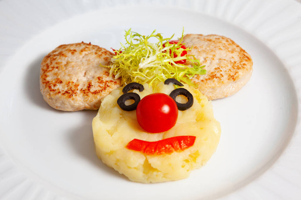 Restaurant serves children menu. Fun healthy food for kids. cutlets potatoes and vegetables, brightly colored - Photo, Image