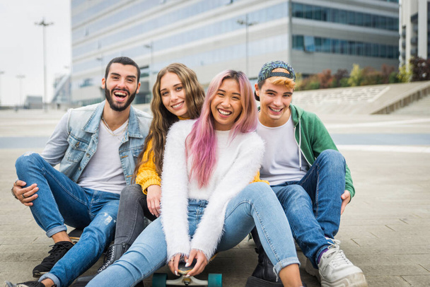 Happy young people meeting outdoors - Group of cheerful teenagers having fun, concepts about teenage, lifestyle and generation z - Фото, зображення