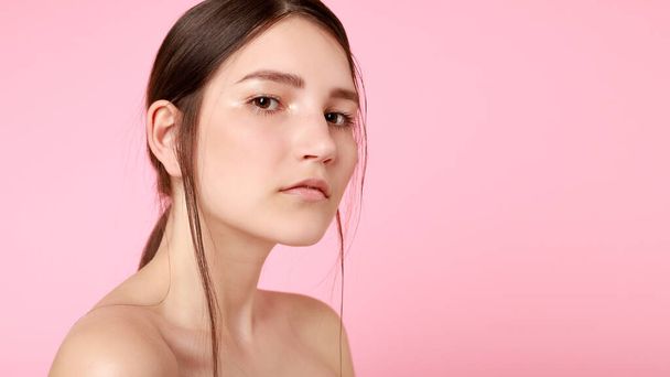 beauty, skin care and people concept - Beauty fashion model girl natural makeup with cute smile on pink background. 16:9 panoramic format. - 写真・画像