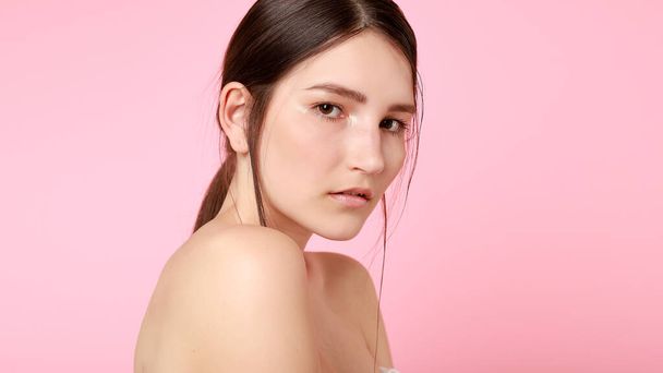 beauty, skin care and people concept - Beauty fashion model girl natural makeup with cute smile on pink background. 16:9 panoramic format. - Foto, afbeelding