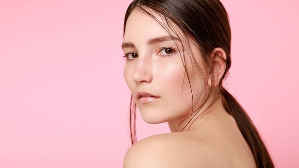 beauty, skin care and people concept - Beauty fashion model girl natural makeup with cute smile on pink background. 16:9 panoramic format. - Фото, изображение