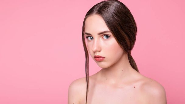Portrait with copy space of charming, cheerful, trendy, attractive, adorable, naked, shirtless girl with modern make up, perfect, ideal skin, isolated on pink background. 16:9 panoramic format. - Foto, Bild