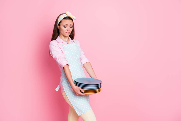Portrait of her she nice attractive pretty sad overwhelmed tired brown-haired waitress holding in hands carrying heavy pile plates comfort service isolated on pink pastel color background - Fotó, kép