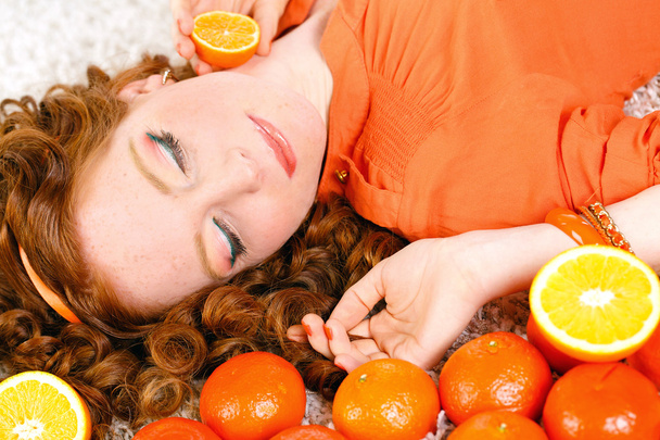 Portrait of attractive caucasian smiling woman isolated on white studio shot with oranges - Φωτογραφία, εικόνα