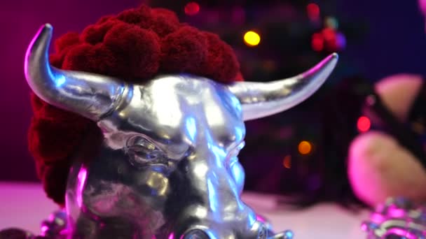 a toy Teddy bear wearing a Santa Claus hat on Christmas day is chained up in the year of the metal bull - Footage, Video