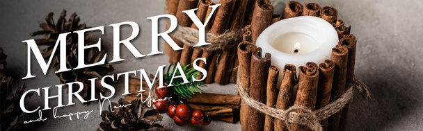 decorated candles with cinnamon sticks near pine cones and merry christmas and happy new year lettering, banner - Foto, imagen