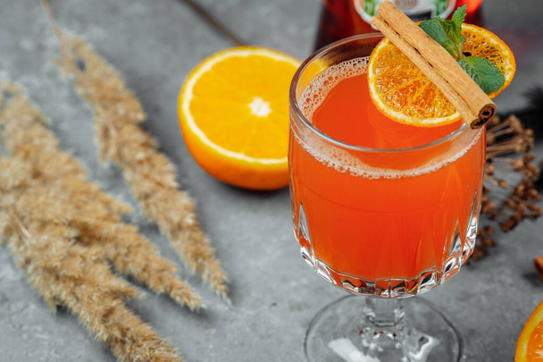 Warming winter cocktail with aperol. Hot aperol. Cocktail For New Years and Christmas. Christmas winter cocktail with aperol spritz martini pineapple juice and spices. - Zdjęcie, obraz