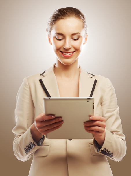 Business woman uses a mobile tablet computer - 写真・画像