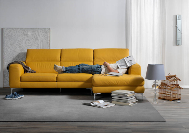 Single shot photo of a room with a sofa and person - Photo, Image