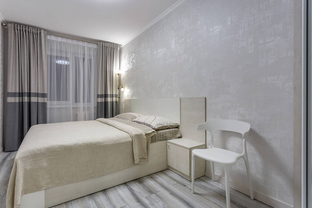 MINSK, BELARUS - SEPTEMBER, 2020: Interior of the modern luxure bedroom in studio apartments in light color style - Фото, зображення