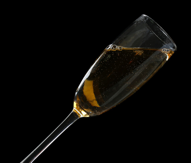 Glass of champagne, on black background - Foto, Imagen