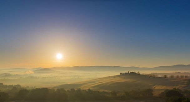 The rolling hills and green fields at sunrise, Tuscany, Italy - Photo, Image